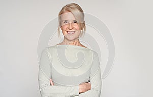 Portrait of beautiful senior woman smiling. 50 years old blonde lady