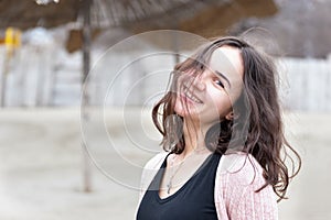 Portrait of beautiful sensitive young girl or woman posing outdoors in casual clothes with smile and adorable eyes