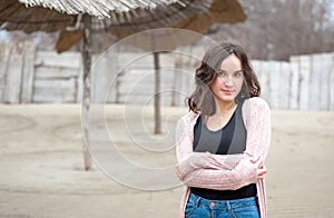 Portrait of beautiful sensitive young girl or woman posing outdoors in casual clothes with smile and adorable eyes