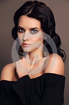 Portrait of beautiful sensual woman with dark hair with bijou