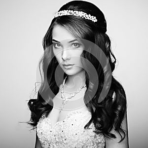Portrait of beautiful sensual woman with elegant hairstyle. Wedding dress