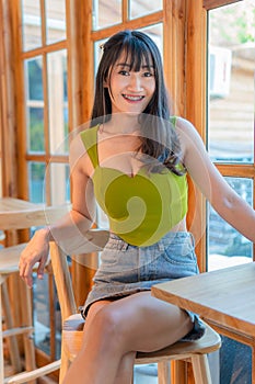 Portrait of beautiful sexy asian woman Wearing a green strapless dress and jean skirt