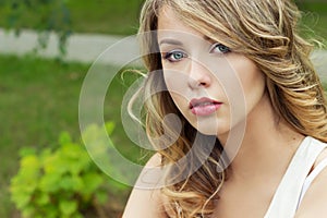 Portrait of beautiful blonde girl in a Park with large plump lips