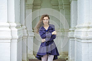 Portrait of a beautiful young woman in dark blue coat