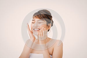 Portrait of Beautiful Skin care woman enjoy and happy, touching her face,isolated with clipping path