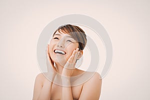 Portrait of Beautiful Skin care woman enjoy and happy, touching her face,isolated with clipping path