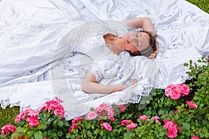 Portrait of beautiful sleeping woman in white long