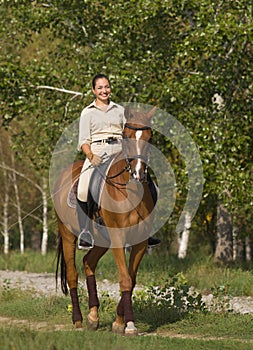 Portrait of beautiful smiling brunette horsewoman