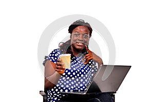 Portrait of a beautiful smiling businesswoman with laptop and holding a cup of tea