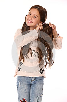 Portrait of beautiful smiling child girl in blue jeans