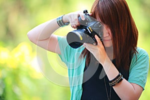 Portrait of beautiful smiling girl,with digital camera in her hands