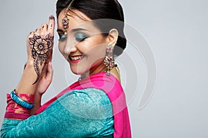 Portrait of beautiful smiling indian girl. Young indian woman model with traditional jewelry set