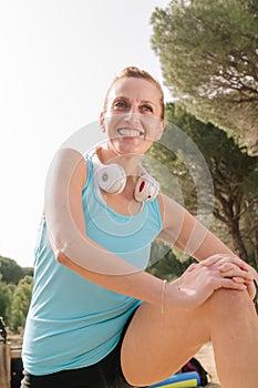 Portrait of a beautiful smiling senior woman doing sports outdoors. 40S