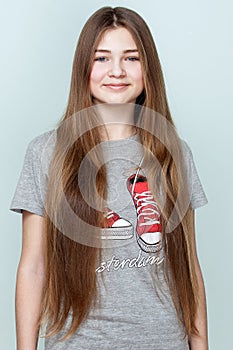 Portrait of a beautiful smiling teenage girl with long hair