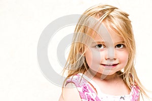 Portrait of Beautiful Smiling Toddler Girl with Blonde Hair