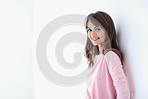 Portrait of beautiful smiling woman with crossed arms on white b