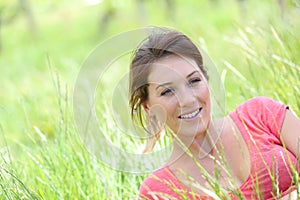 Portrait of beautiful smiling woman in fileds full of high grass