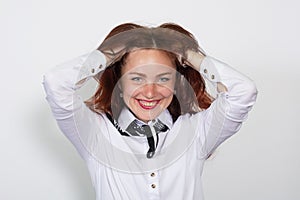 Portrait of a beautiful smiling woman looking at camera over white