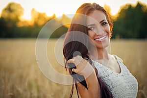 Portrait beautiful smiling woman at sunset closeup