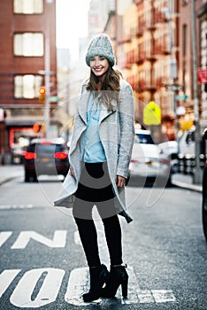 Portrait of beautiful smiling woman walking on city street