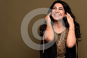 Portrait of beautiful smiling young muslim arabian woman looking at camera, copy space