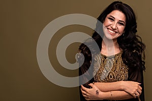 Portrait of beautiful smiling young muslim arabian woman looking at camera, copy space