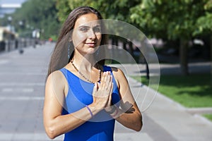 Portrait of beautiful smiling young woman enjoying yoga, relaxing, feeling alive, breathing fresh air