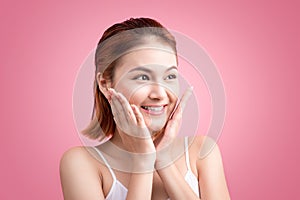 Portrait of a beautiful smiling young woman with natural make-up. Skincare, healthcare. Healthy teeth. Studio shot. Isolated on P