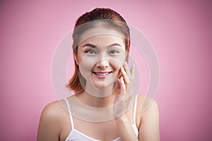 Portrait of a beautiful smiling young woman with natural make-up. Skincare, healthcare. Healthy teeth. Studio shot. Isolated on P