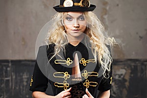 Portrait of a beautiful steampunk woman hat-bowler hat over grunge background.