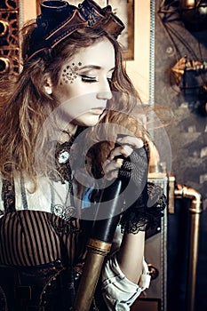 Portrait of a beautiful steampunk woman, with a telescope on a g