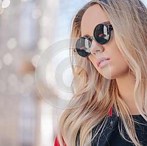 Portrait of beautiful stylish blonde woman in black sunglasses in outdoor