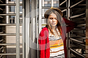 Portrait of a beautiful, stylish young Caucasian woman with a toothy smile, long developing hair in the wind and a straw