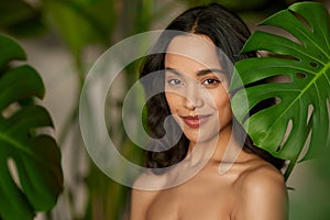 Portrait of beautiful tanned girl with natural makeup in the nature