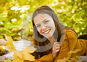 Portrait of a beautiful teenage girl having fun in autumn park