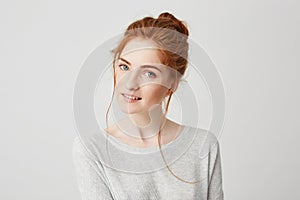 Portrait of beautiful tender redhead girl smiling posing looking at camera over white background.