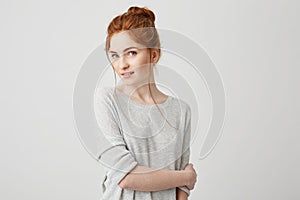 Portrait of beautiful tender redhead girl smiling posing looking at camera over white background.