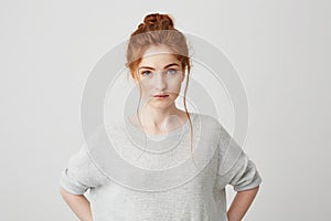 Portrait of beautiful tender redhead girl smiling posing looking at camera over white background.