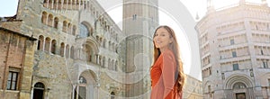 Portrait of beautiful tourist woman in Parma with Cathedral, Bell tower and Baptistery. Panoramic view of traveler girl with Parma