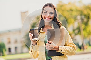 Portrait of beautiful trendy girl entrepreneur drinking latte holding carrying laptop traveling abroad anternational