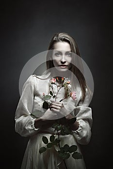 Portrait of a beautiful vampire with rosebud photo