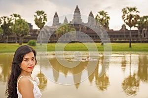 Portrait of beautiful Vietnamese millennial girl posing next to Angkor Wat, Siem Reap