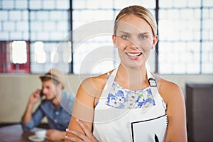 Portrait of a beautiful waitress taking an order