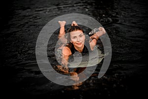 Portrait of a beautiful wakesurfer swimming in river