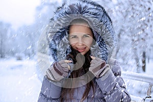 Portrait of a beautiful winter woman in fur ha