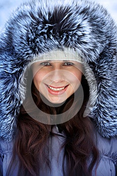 Portrait of a beautiful winter woman in fur ha