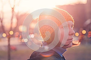 Portrait of beautiful woman in 40s against autumn sunlight