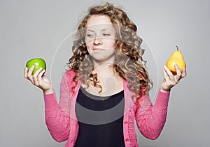 Portrait of beautiful woman with an apple and pear