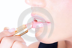 Portrait of beautiful woman applying lipstick