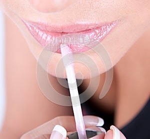 Portrait of a beautiful woman applying makeup